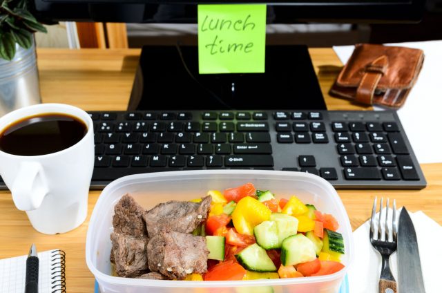 39846110 - homemade lunch box at modern stylish work place, view from above