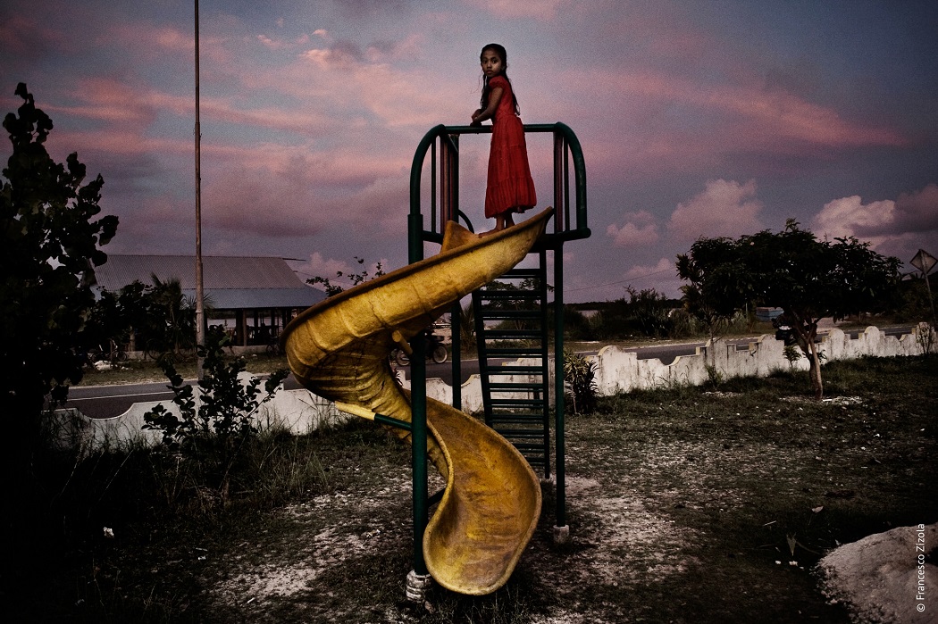 A little girl plays on a slide in Hithadu. Addu atoll, Maldives. June 2007. From the ‘Maldives, a lost paradise series’ on human rights violations in the Maldives.