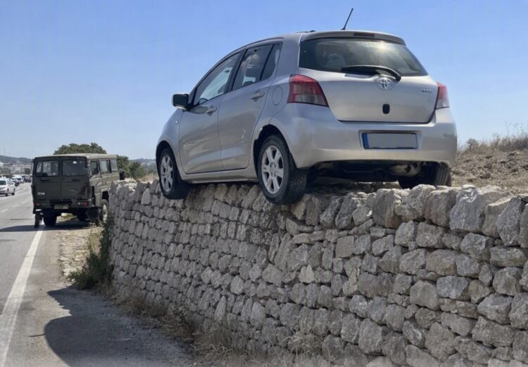 Scena surreale sulla Modica-Pozzallo, auto finisce a cavallo su un muretto di pietra a secco